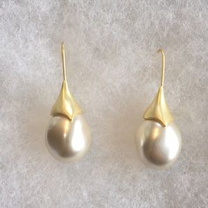 Beautiful pearl drop costume and gold earrings.